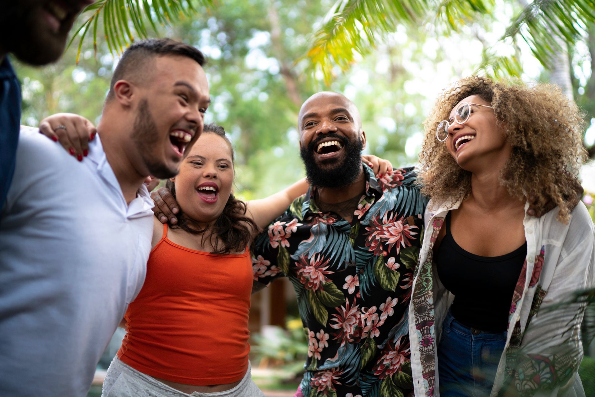 A group of people are standing next to each other and laughing.