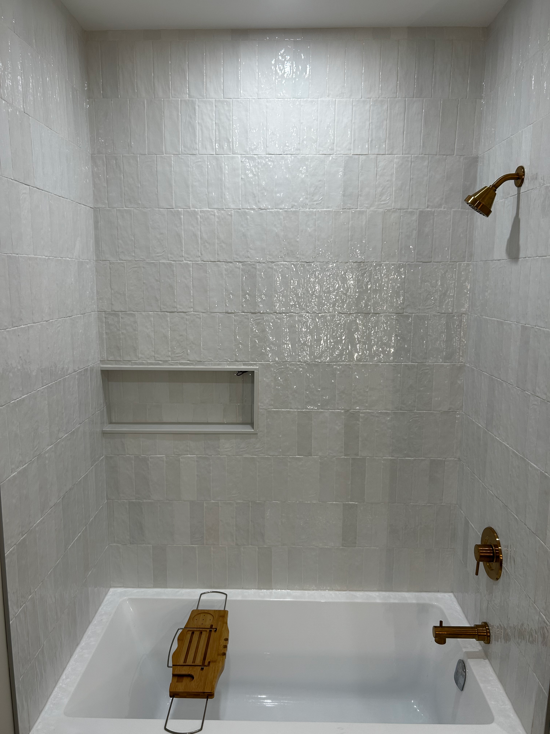 A bathroom with a bathtub and a shower.