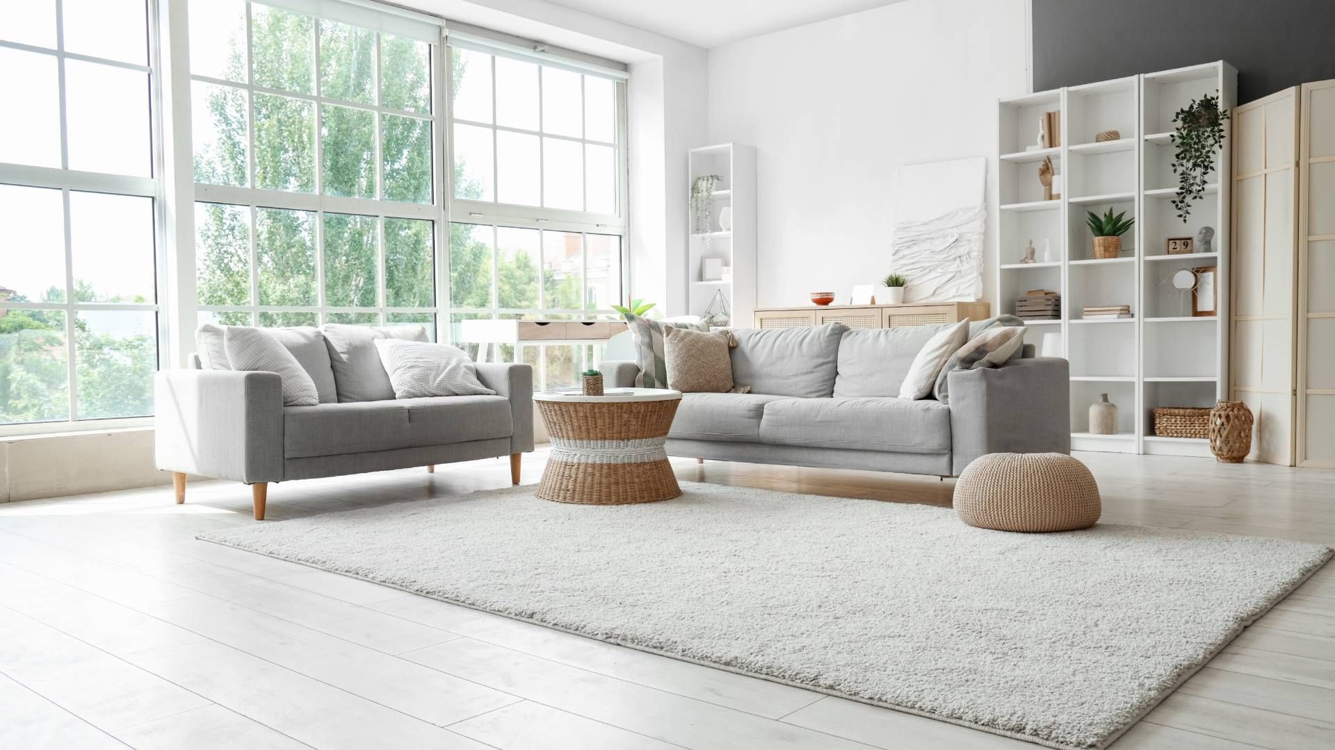 A living room filled with furniture and a large window.