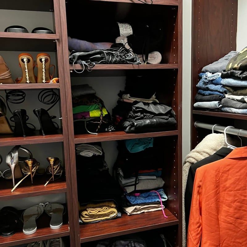 A closet filled with lots of shoes and clothes