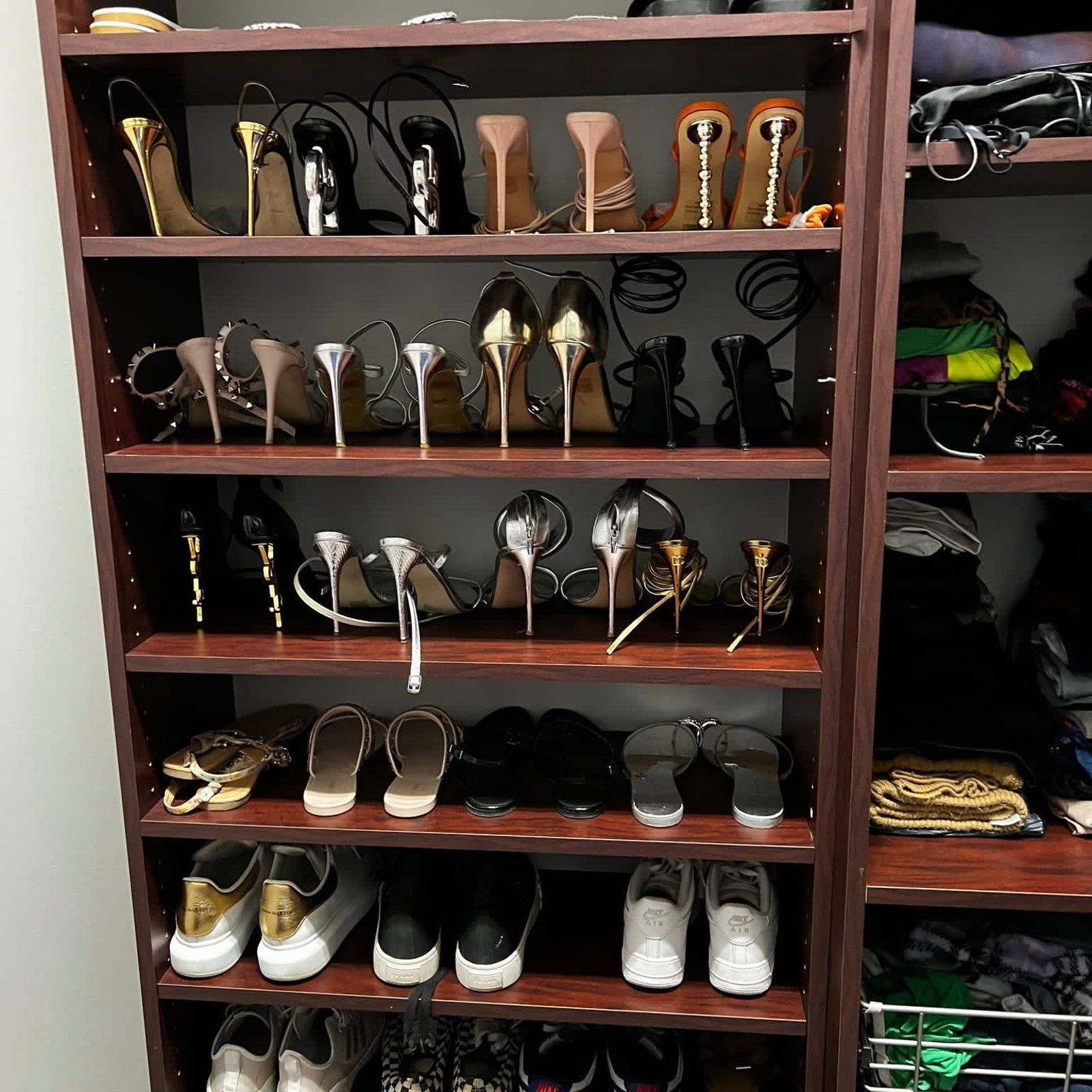 A closet filled with lots of shoes including high heels