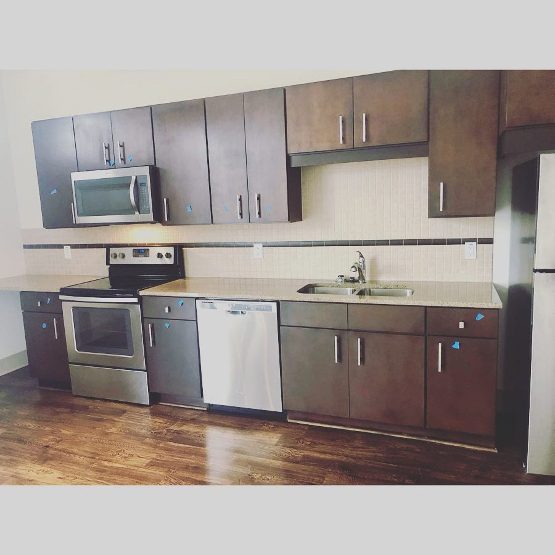 A kitchen with stainless steel appliances and wooden cabinets