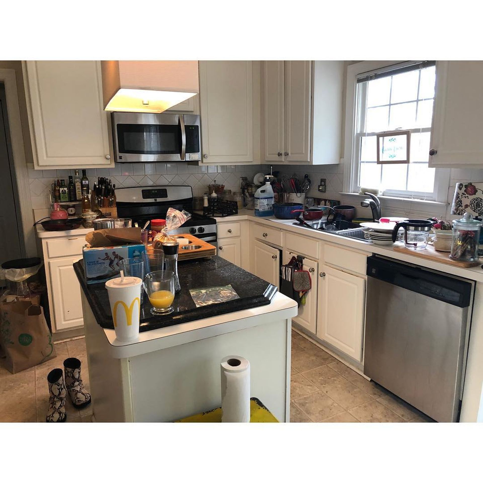 A kitchen with white cabinets and stainless steel appliances.