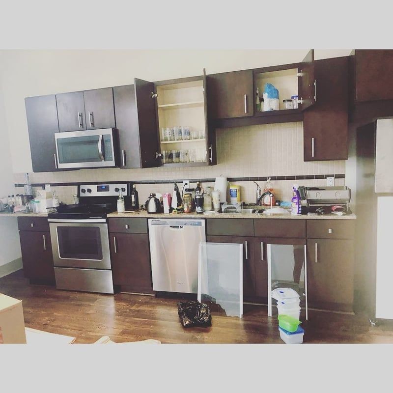 A kitchen with stainless steel appliances and brown cabinets