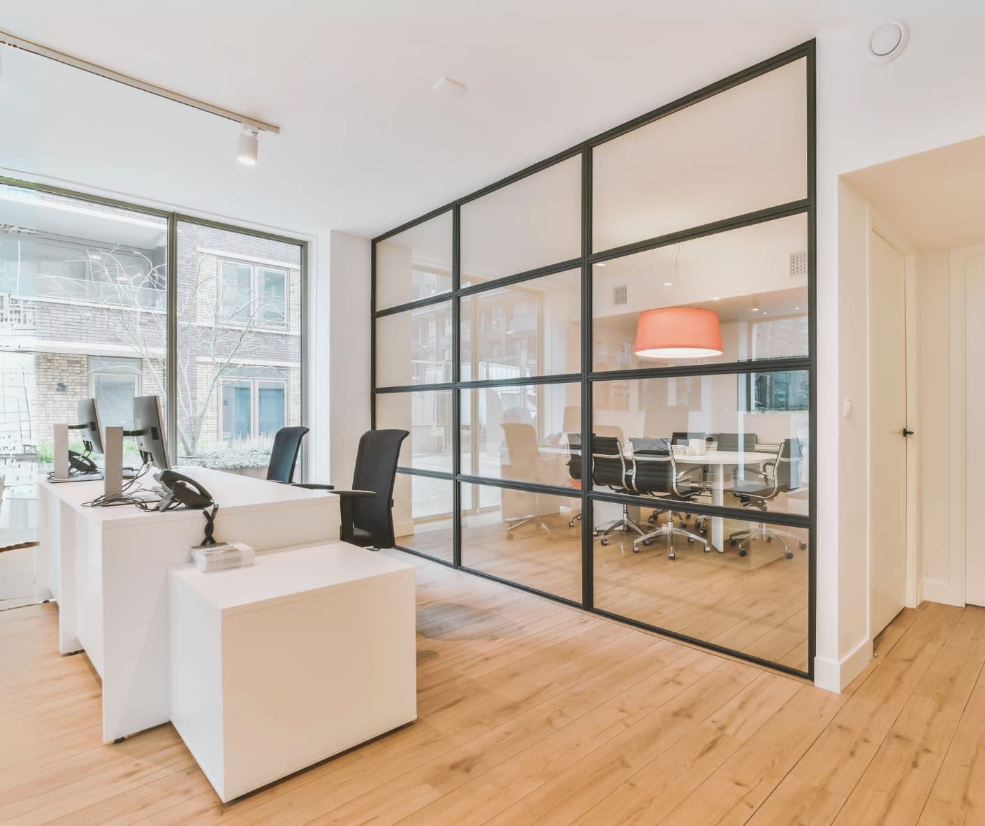 A room with a lot of windows and a glass wall.