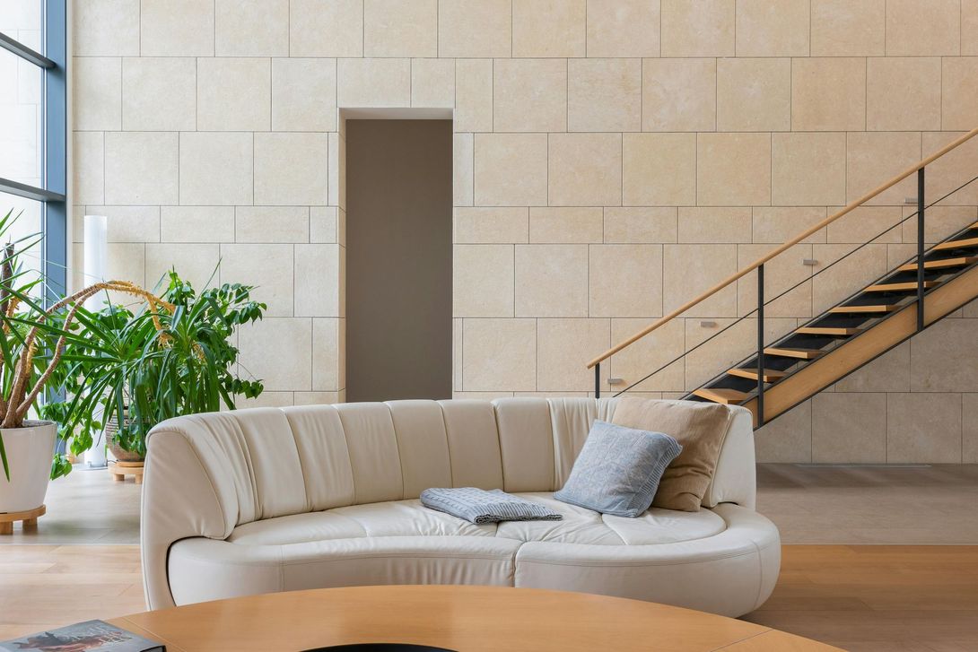 A living room with a couch , table , and stairs.