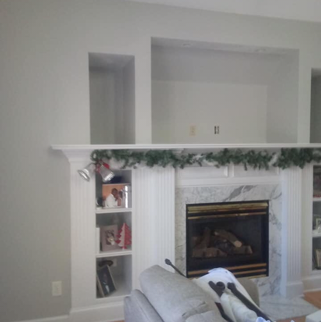 A living room with a fireplace and a couch