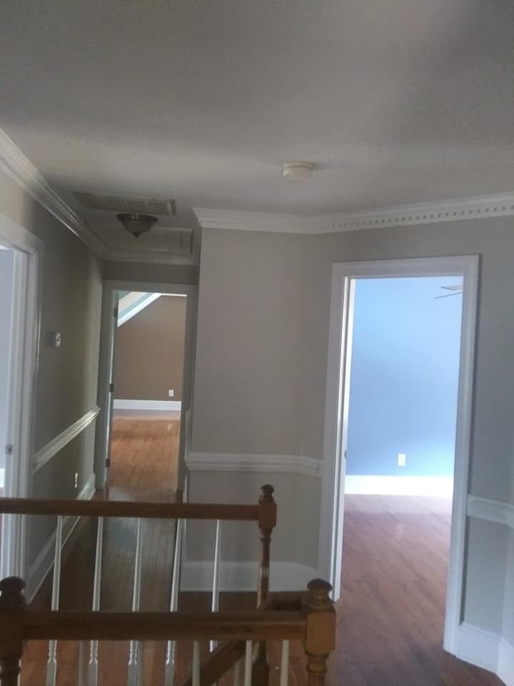 An empty hallway with a wooden railing and stairs
