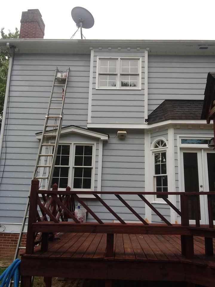 A ladder is leaning against the side of a house