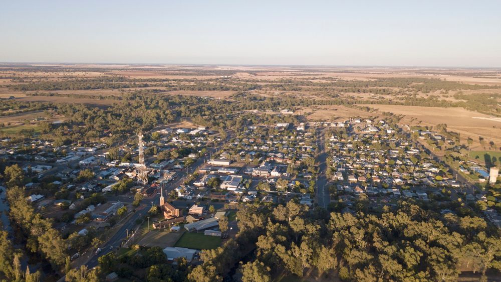 Aerial View of a Small Rural Town With Houses, Trees, and a Church — Darren Smith Roofing In Kotara, NSW