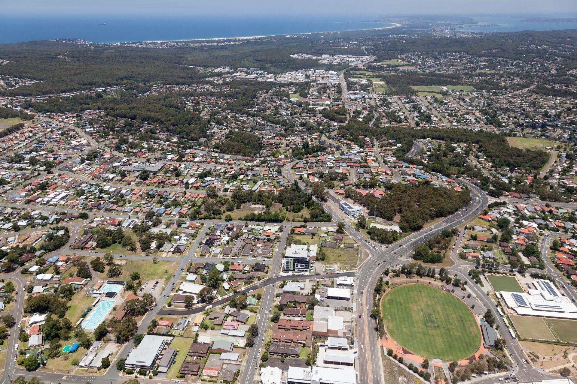 Aerial View of a Suburban Town With Houses, Roads, and a Sports Field — Darren Smith Roofing In Charlestown, NSW