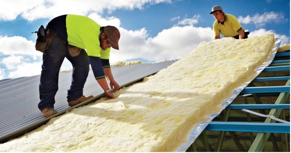 Two Men are Working on the Roof of a Building  — Fascia in Gosford, NSW