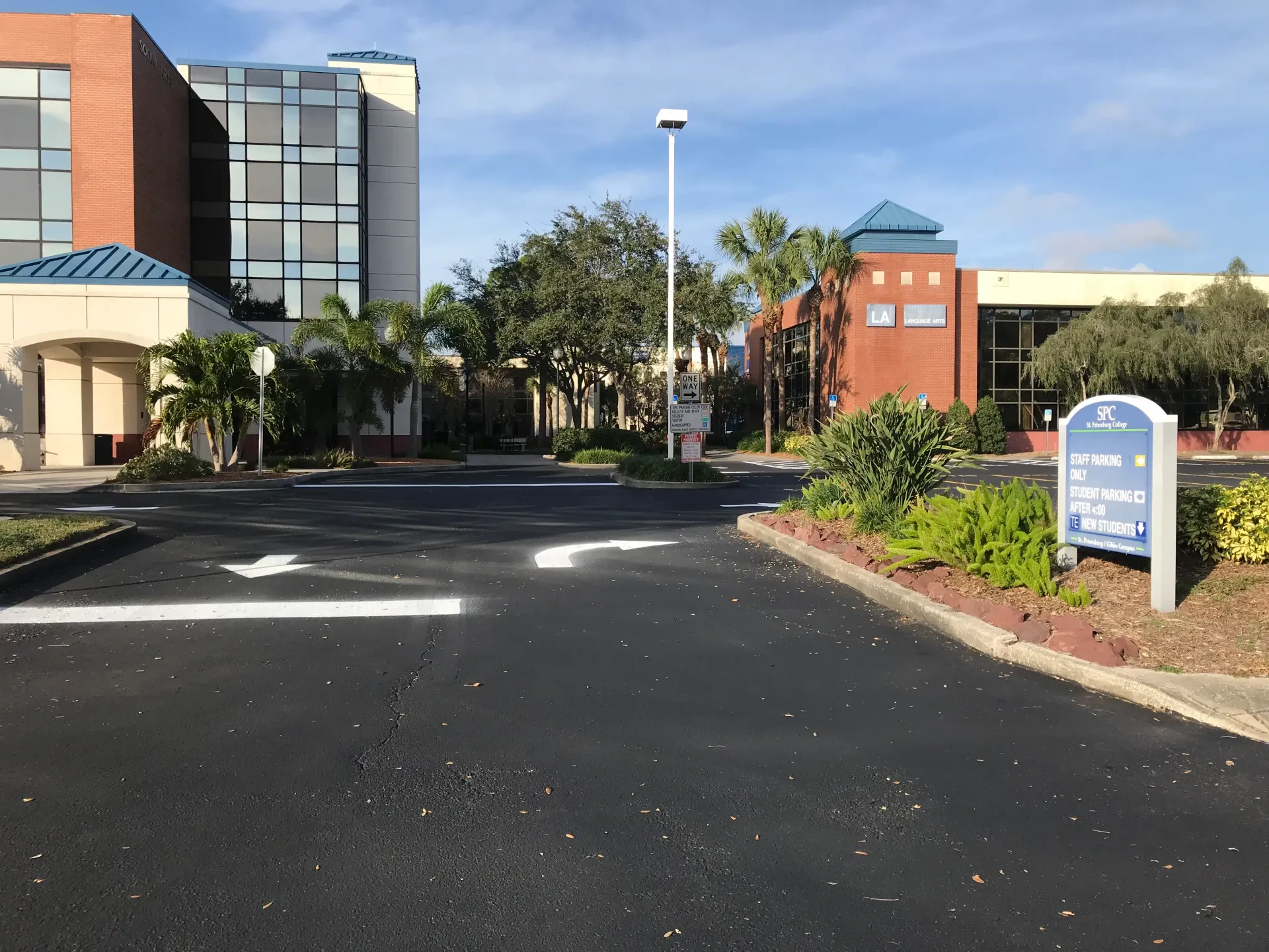 A parking lot in front of a large building