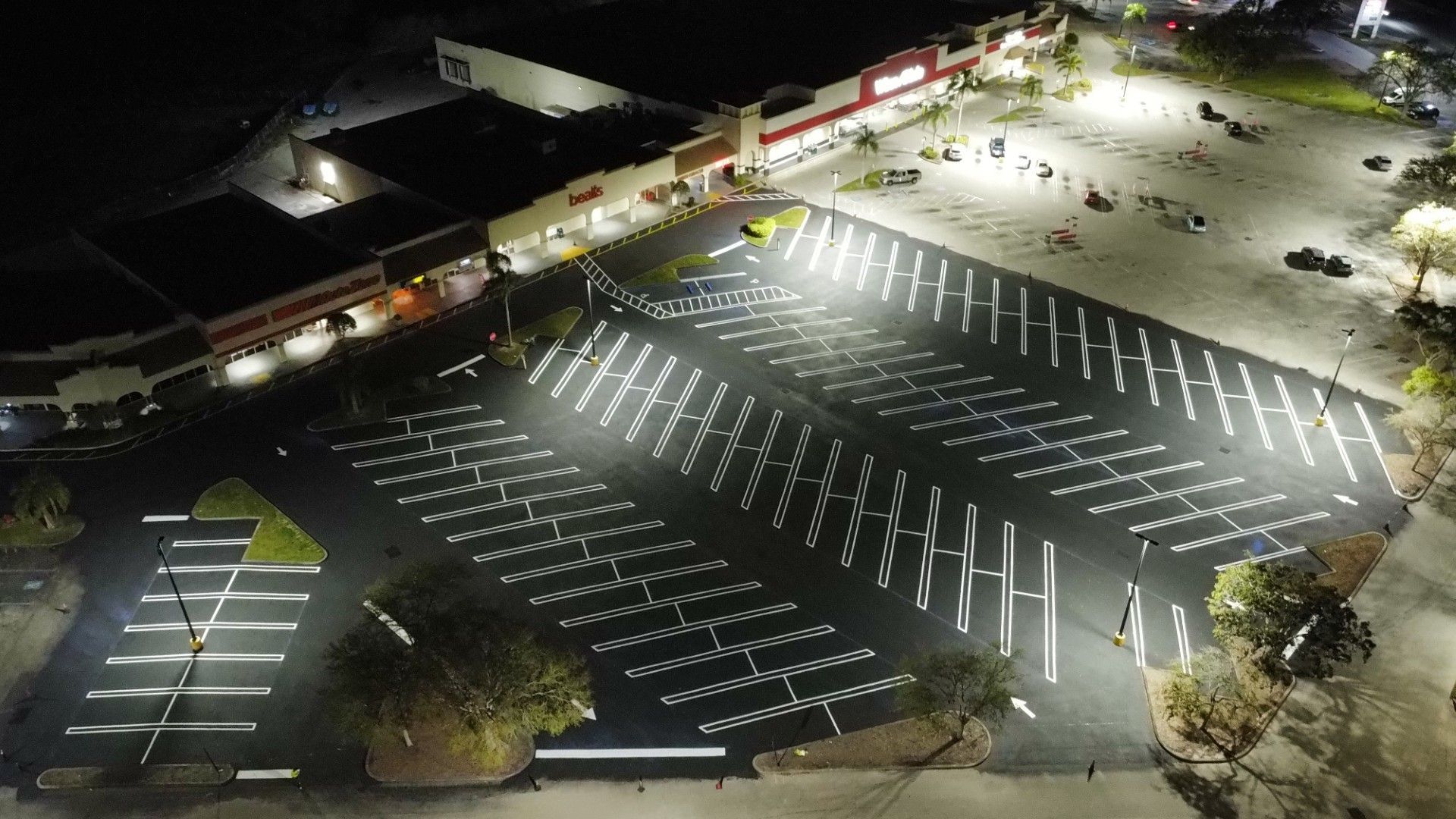 An aerial view of a parking lot lit up at night