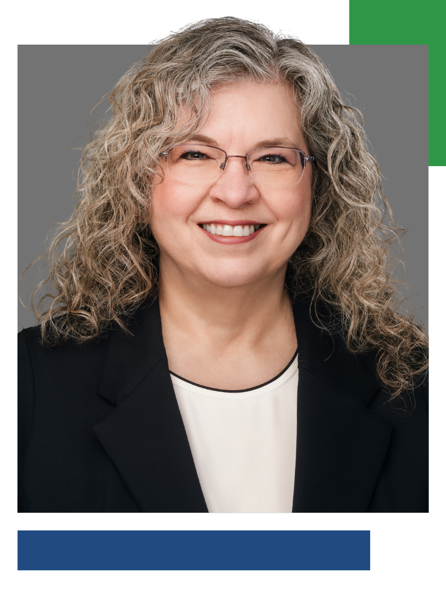 Woman wearing glasses and a blazer smiles, headshot framed by a gray background with green and blue design elements.