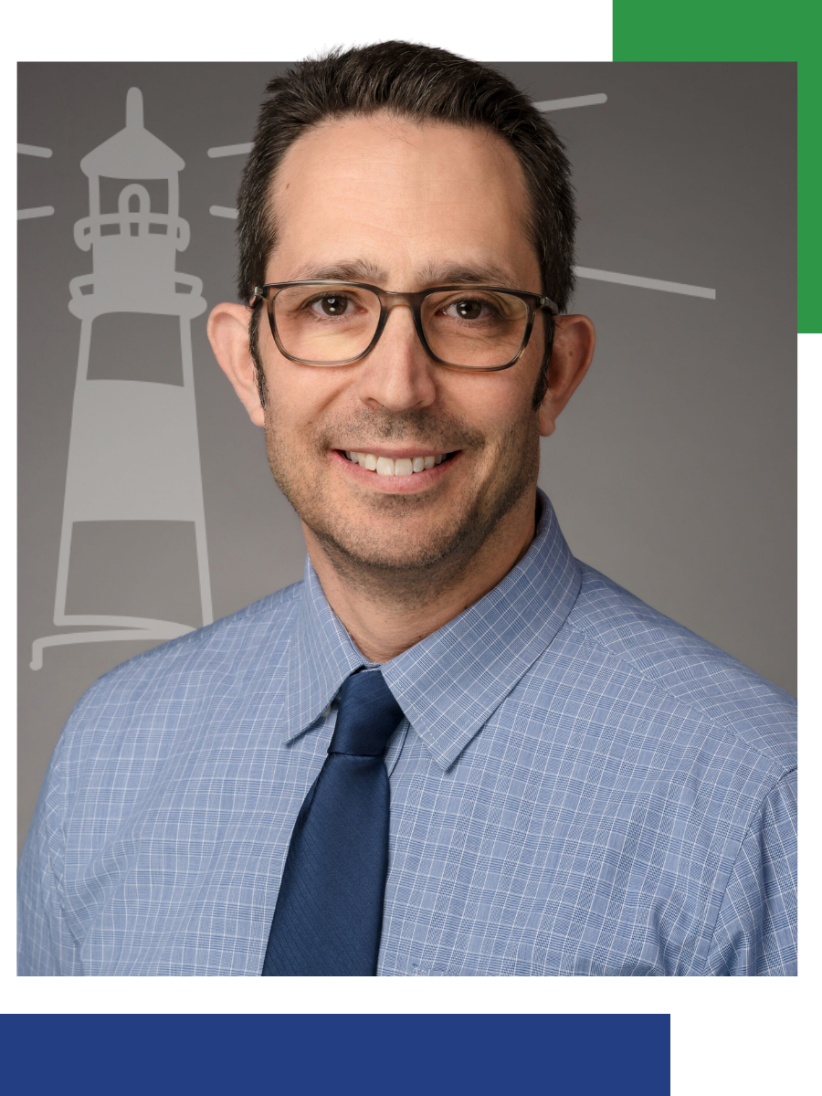 Man wearing glasses and blue tie smiles, gray background with lighthouse outline.