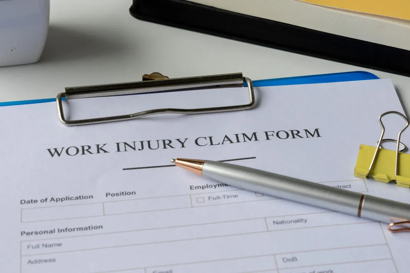 A yellow excavator is sitting on top of a pile of gravel.