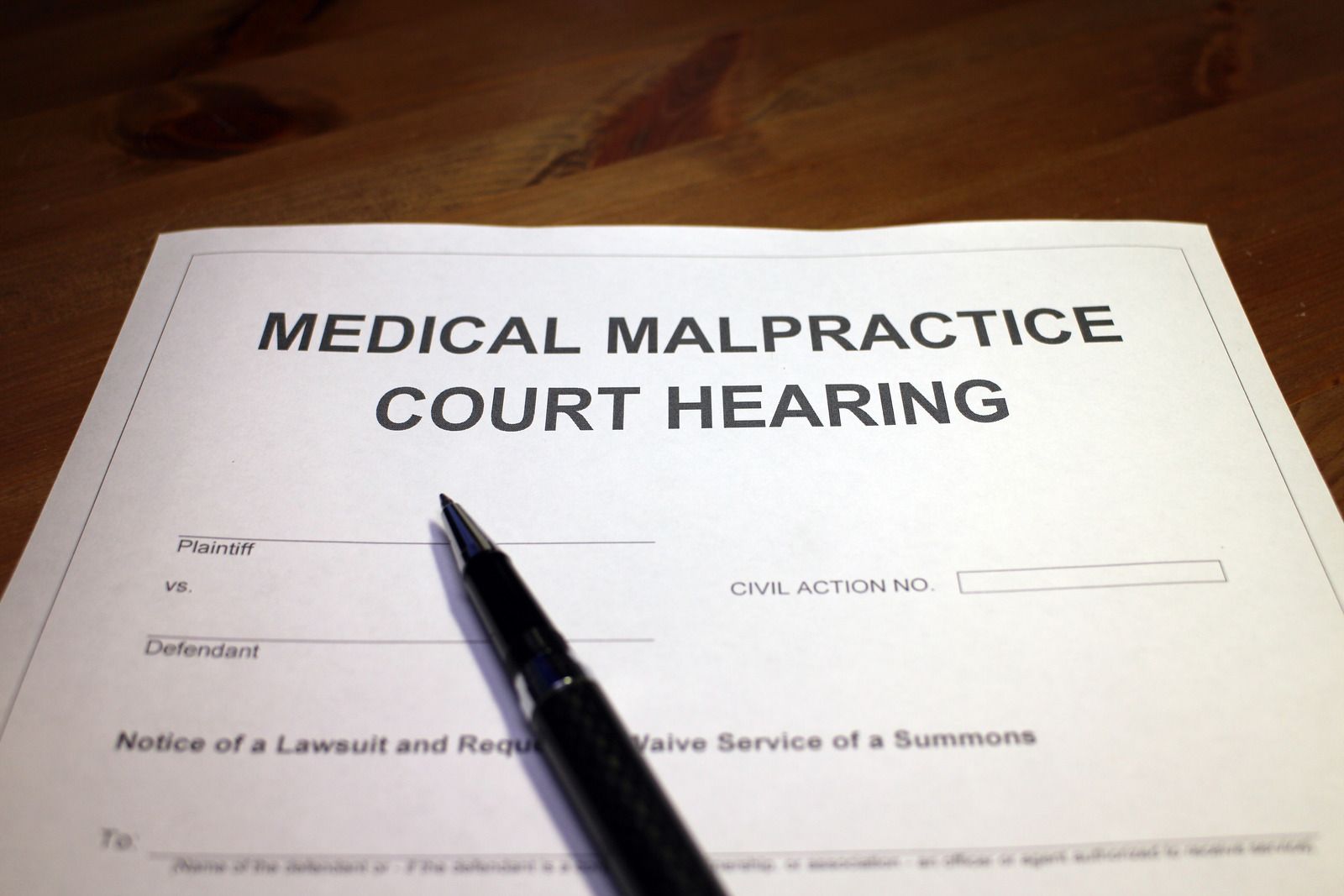 A man wearing a hard hat and goggles is standing in a room.