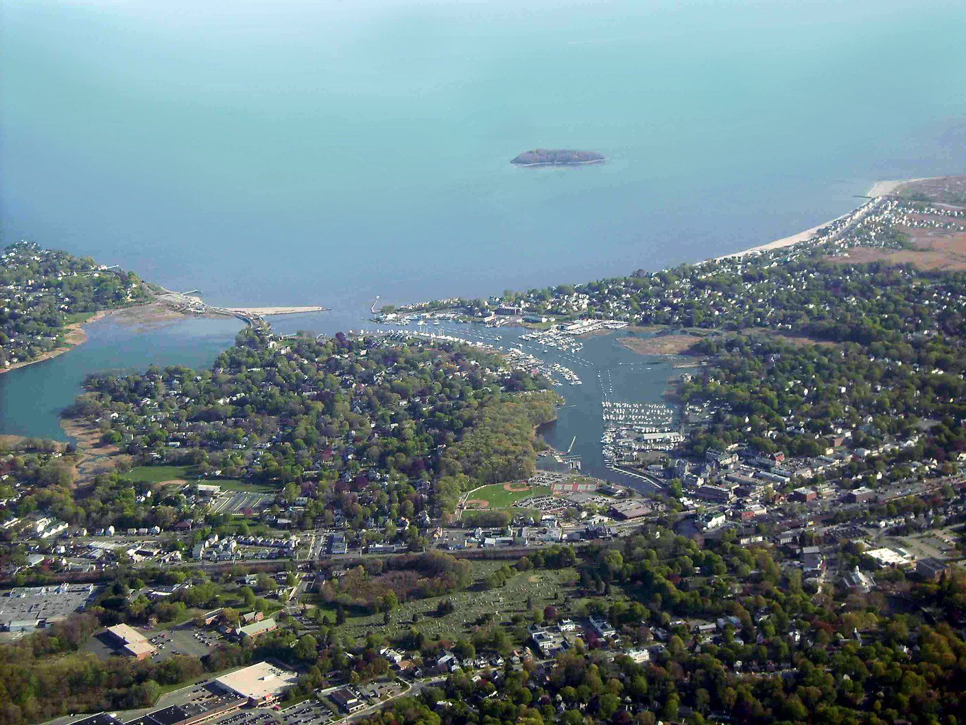 An aerial view of a small town next to a body of water.