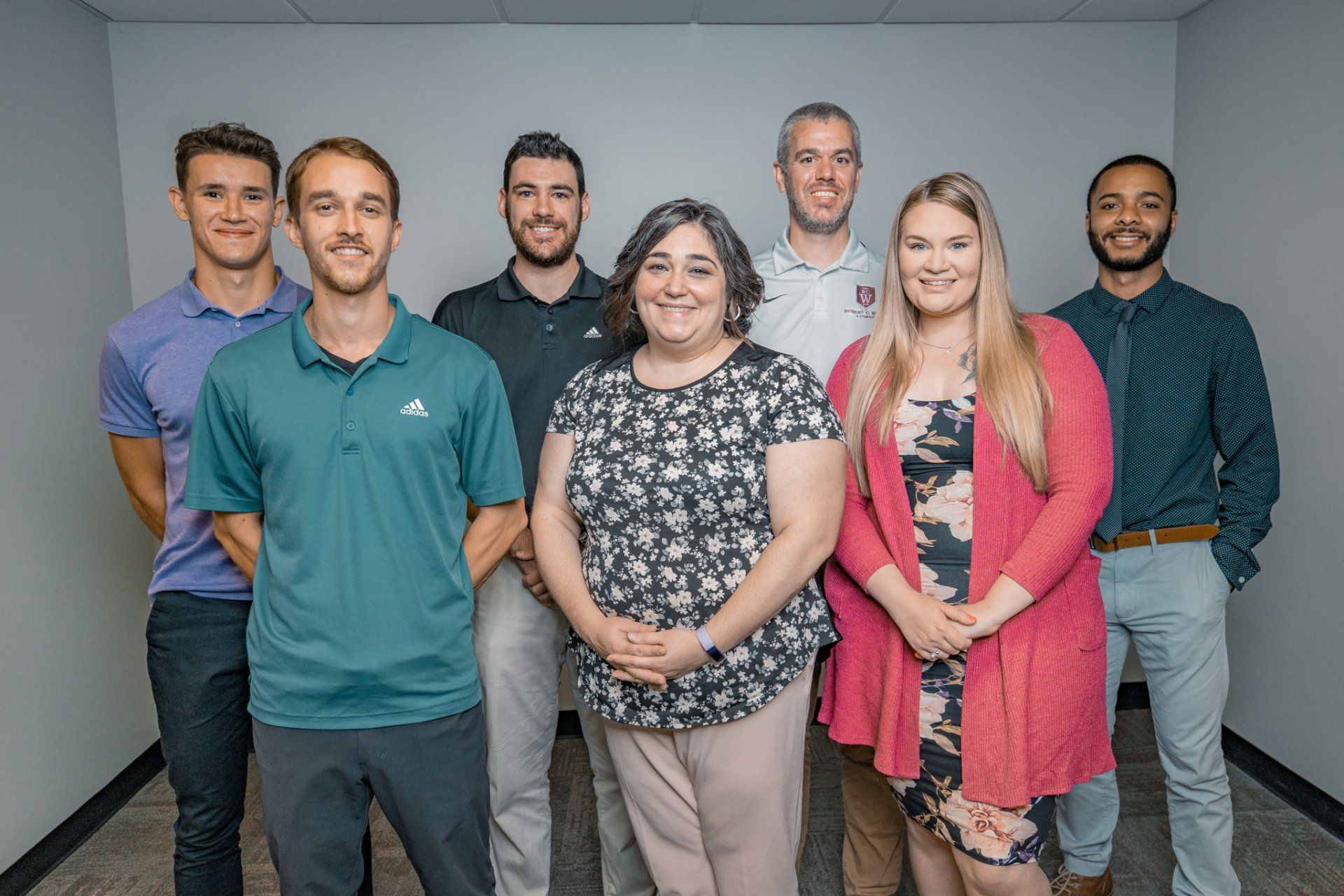 A group of people are posing for a picture in a room.