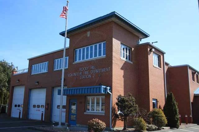 A large brick building with a flag in front of it