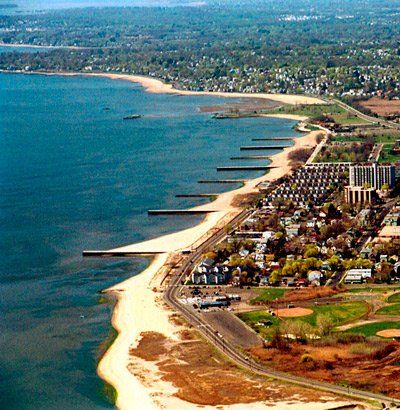 An aerial view of a beach with a city in the background