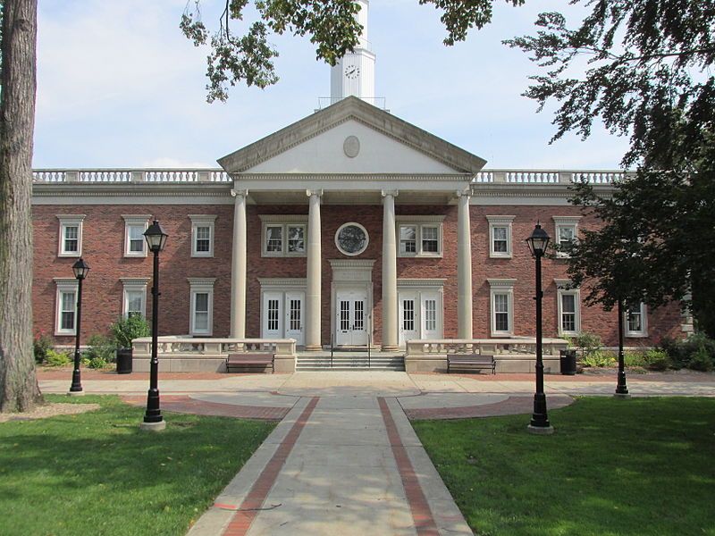 A large brick building with columns and a clock tower