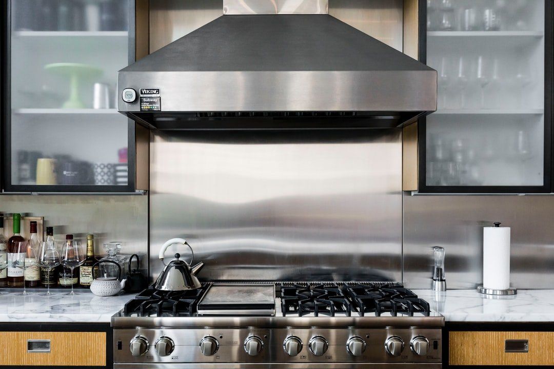 Kitchen Stainless Steel Oven And Range Hood — Gas Appliances in Coffs Harbour, NSW