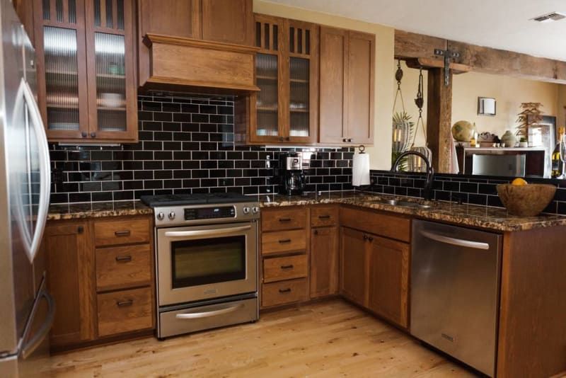 A kitchen with stainless steel appliances and wooden cabinets