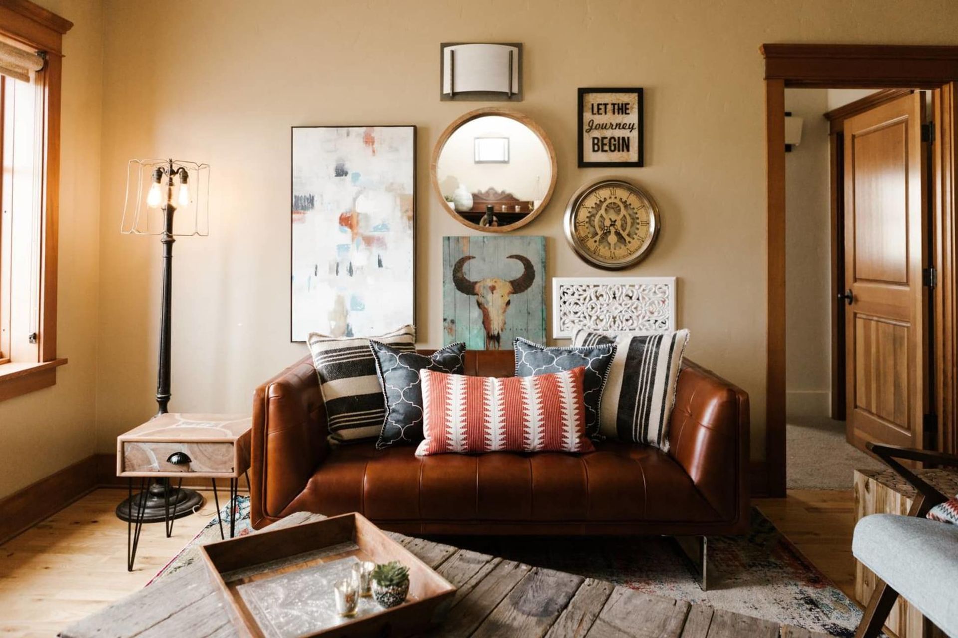 A living room with a brown leather couch and a wooden coffee table.