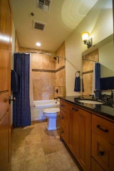 A bathroom with a toilet a sink and a bathtub