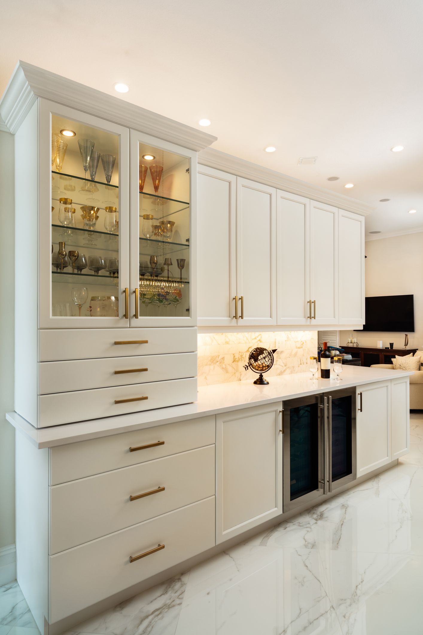 A modern kitchen featuring custom cabinets, white cabinetry, and elegant marble floors in Plano, TX