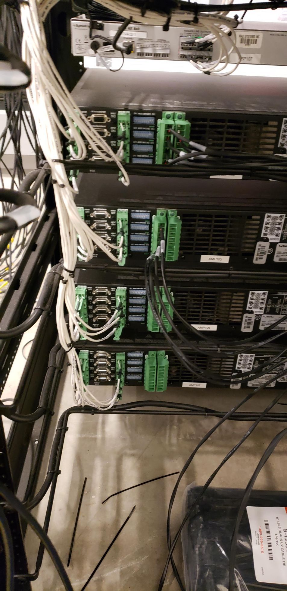 A bunch of wires are connected to a computer in a room.