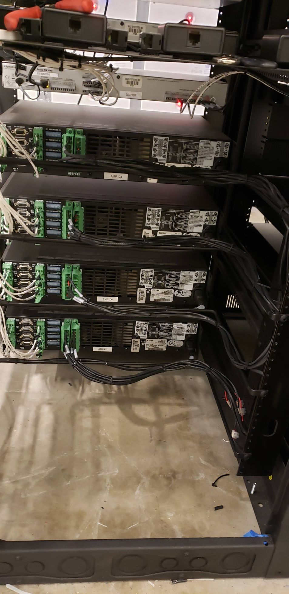 A server rack with a lot of wires coming out of it.