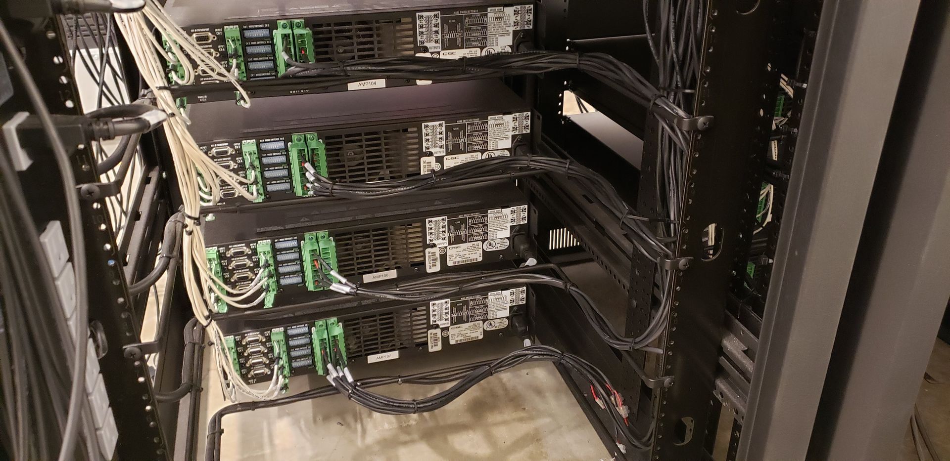 A bunch of wires are connected to each other in a server room.