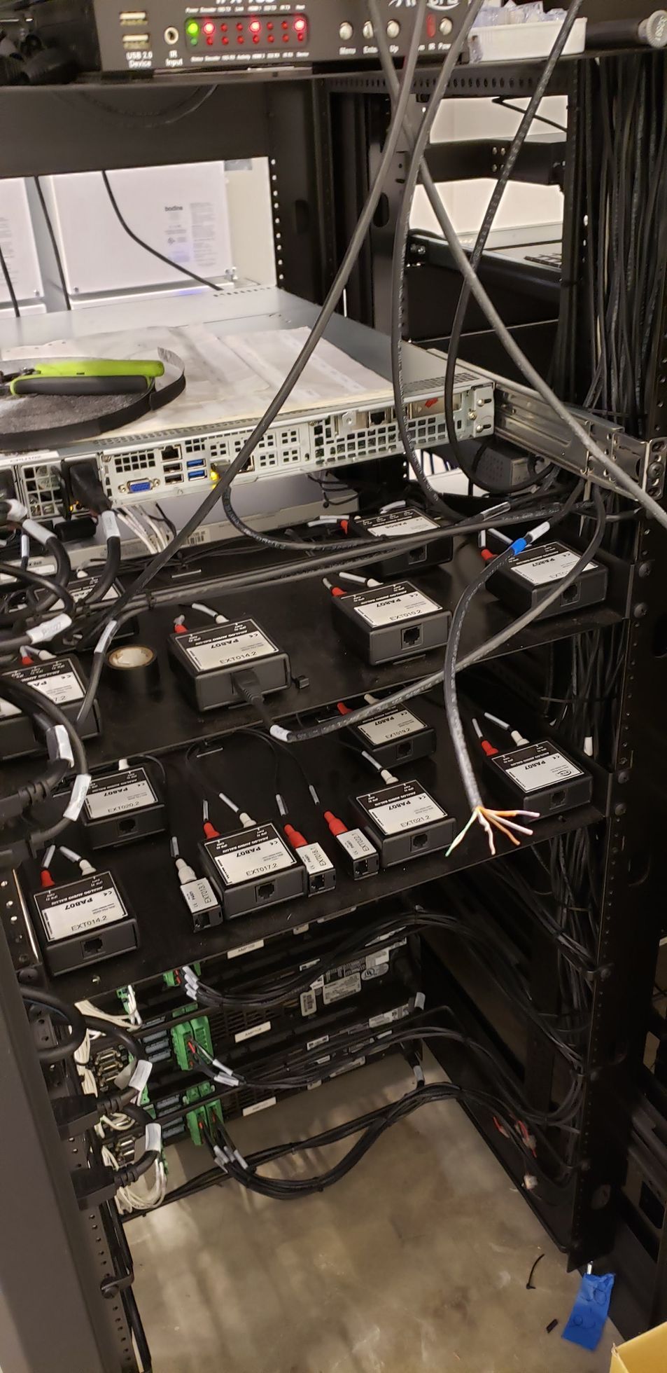 A bunch of wires are connected to a server rack.