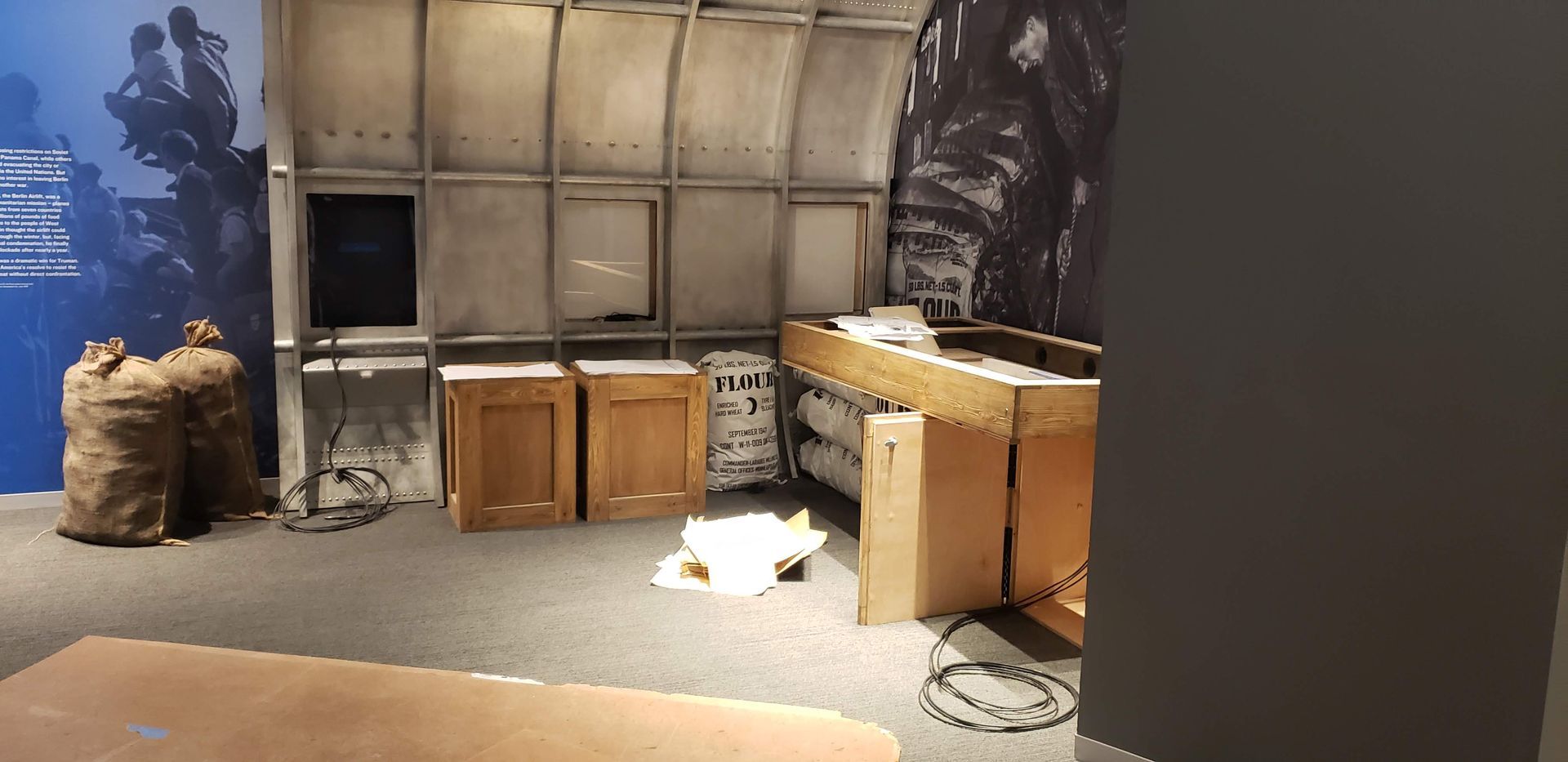 A room with boxes on the floor and a picture on the wall.