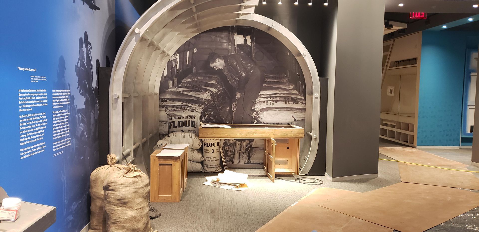 A room with a picture of a tunnel on the wall.