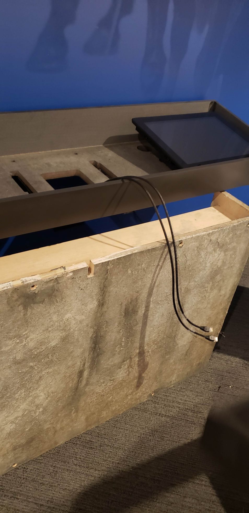 A tablet is sitting on top of a wooden table.