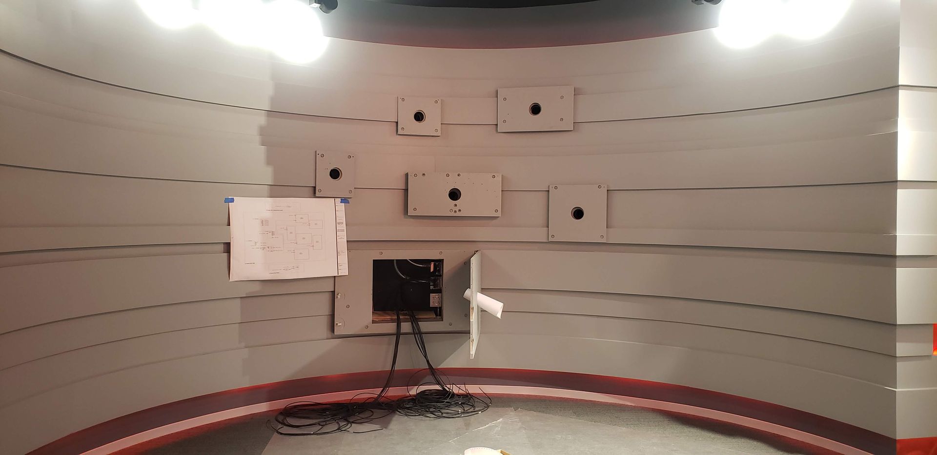 A room with a lot of electrical outlets on the wall.