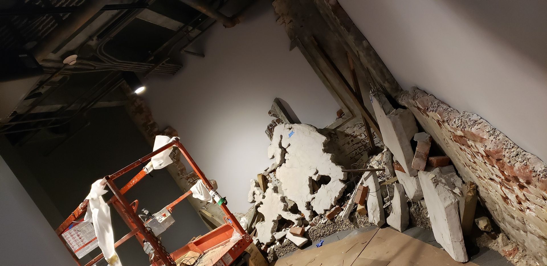 A room with a lot of pieces of concrete on the floor.