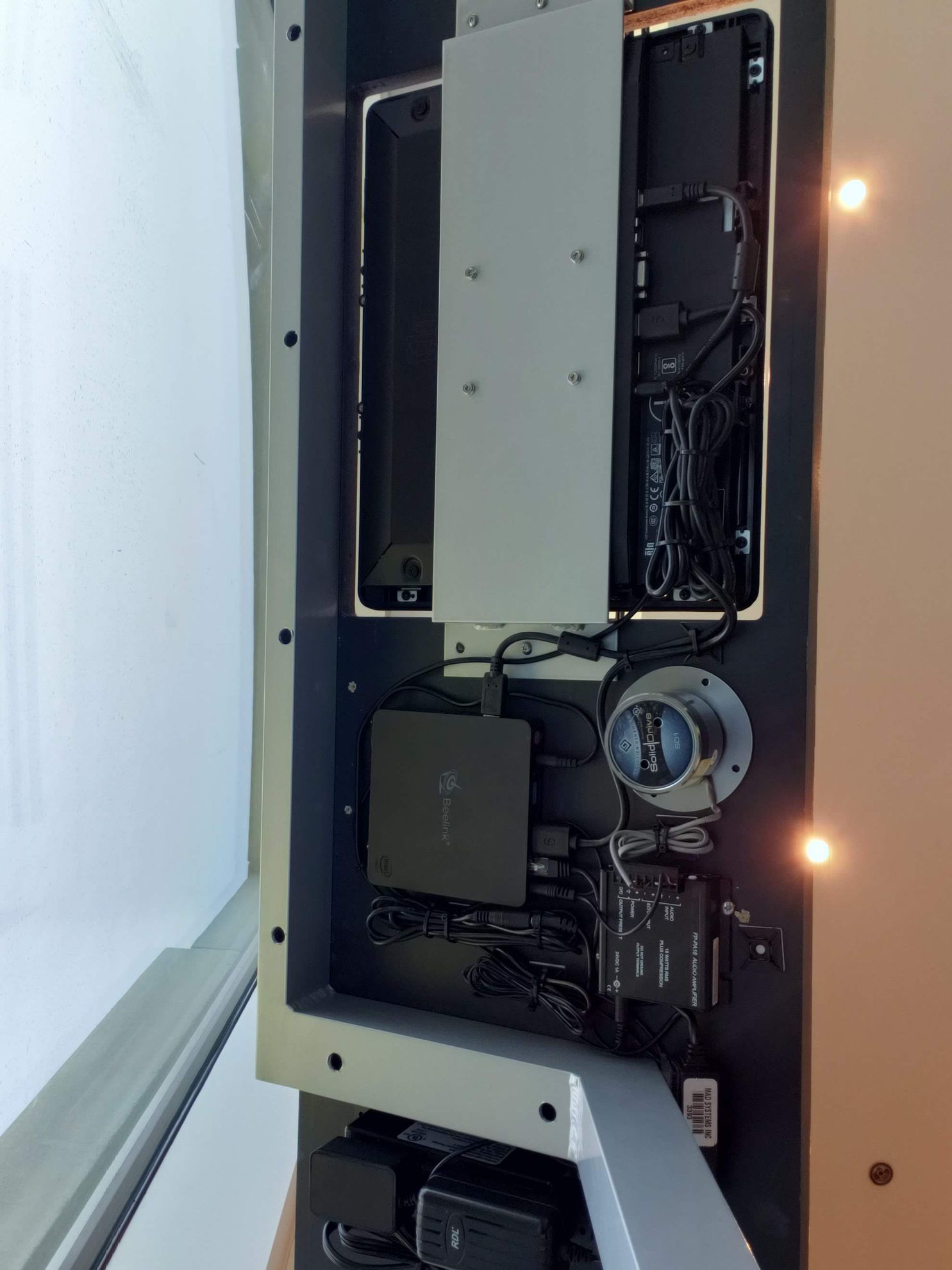 The inside of a computer with a lot of wires coming out of it