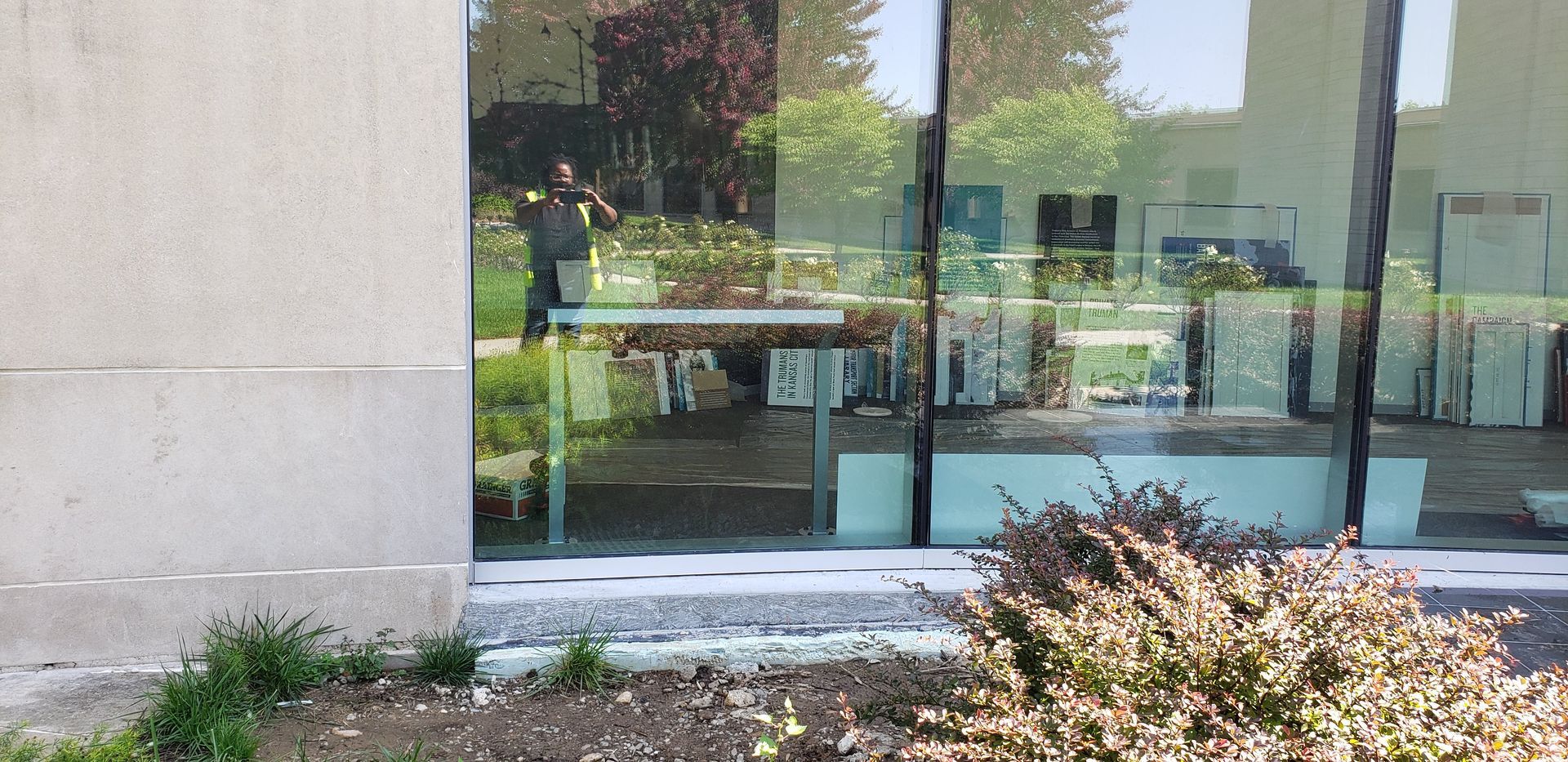 A building with a lot of windows and a bush in front of it.