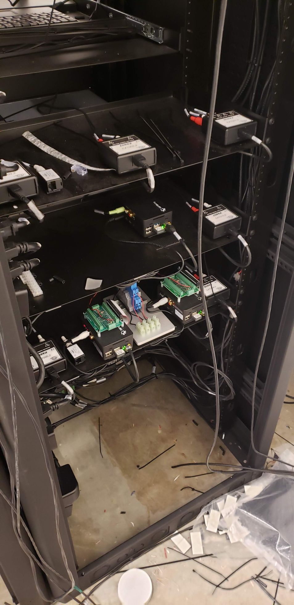 The inside of a server rack with a lot of wires hanging from it.