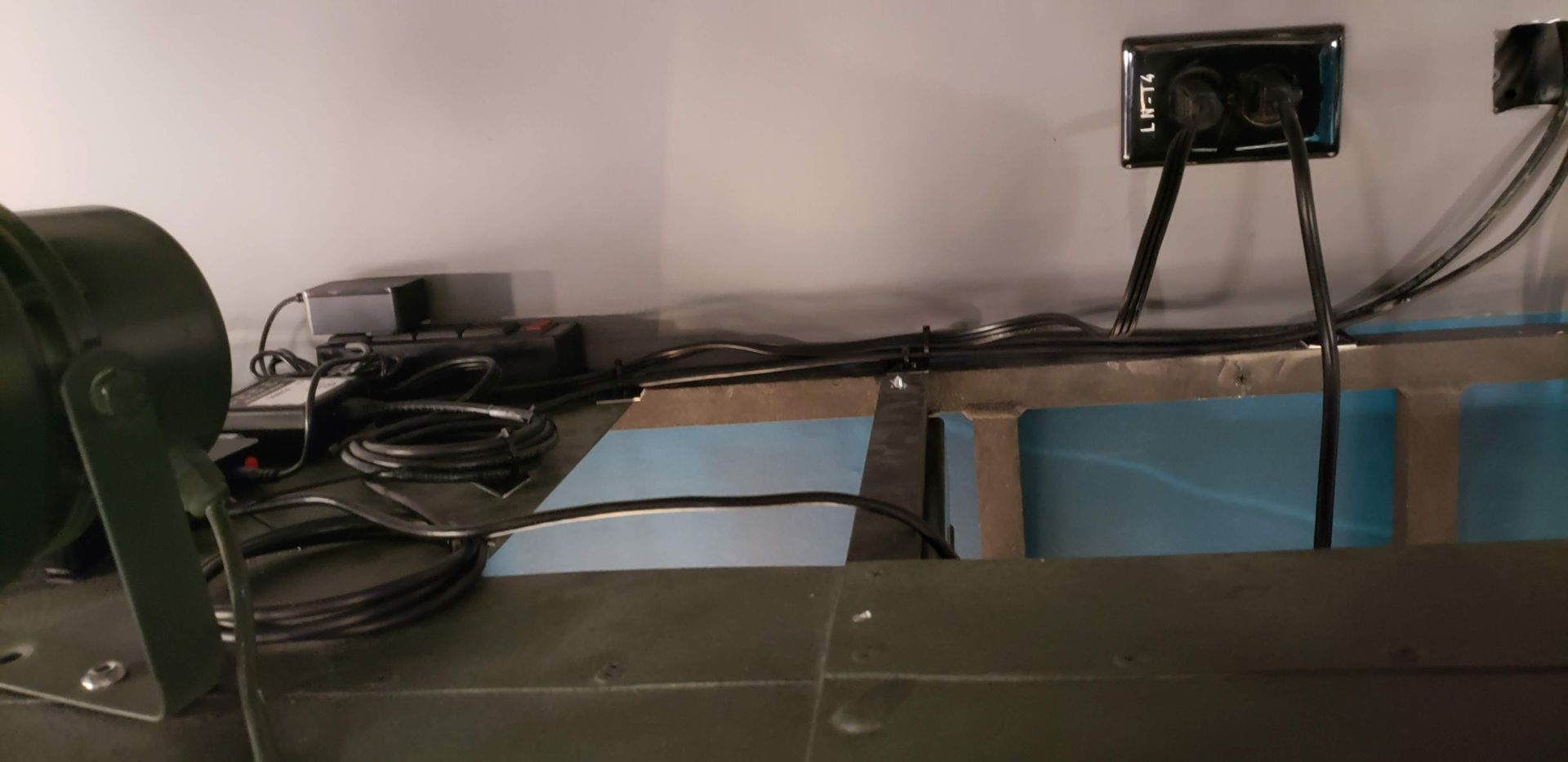 A machine is sitting on a table with a lot of wires coming out of it.