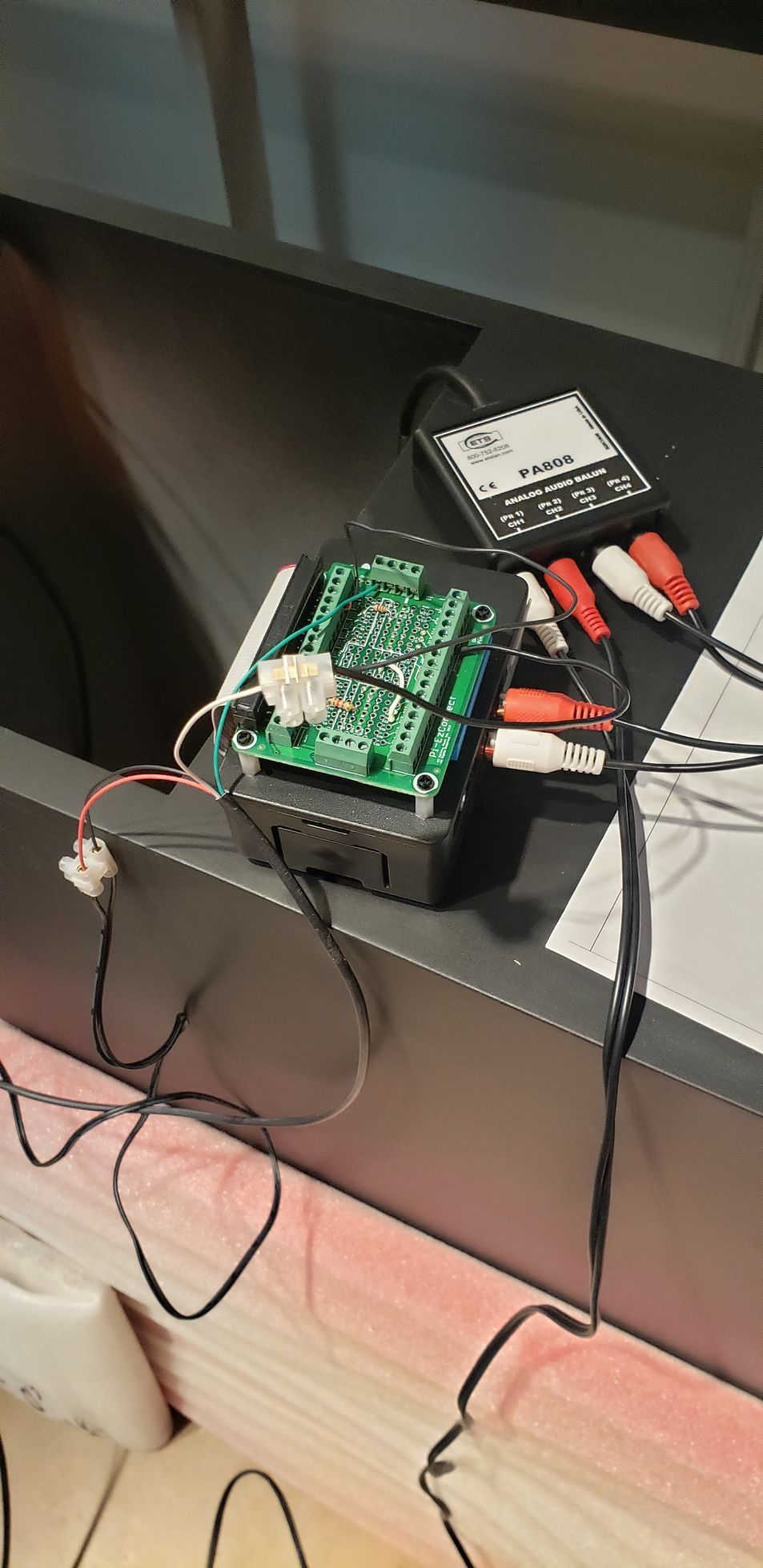 A motherboard is sitting on top of a table next to a bunch of wires.