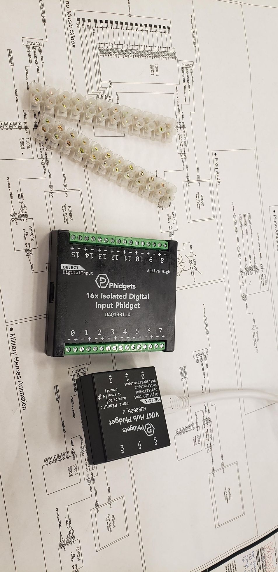 A couple of electronic devices are sitting on top of a piece of paper.