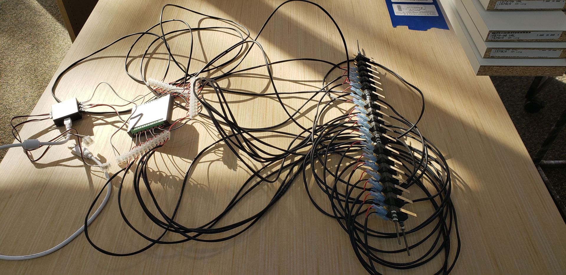 A bunch of wires are laying on a wooden table
