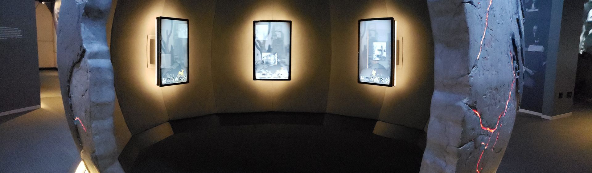 A circular room with three pictures on the wall