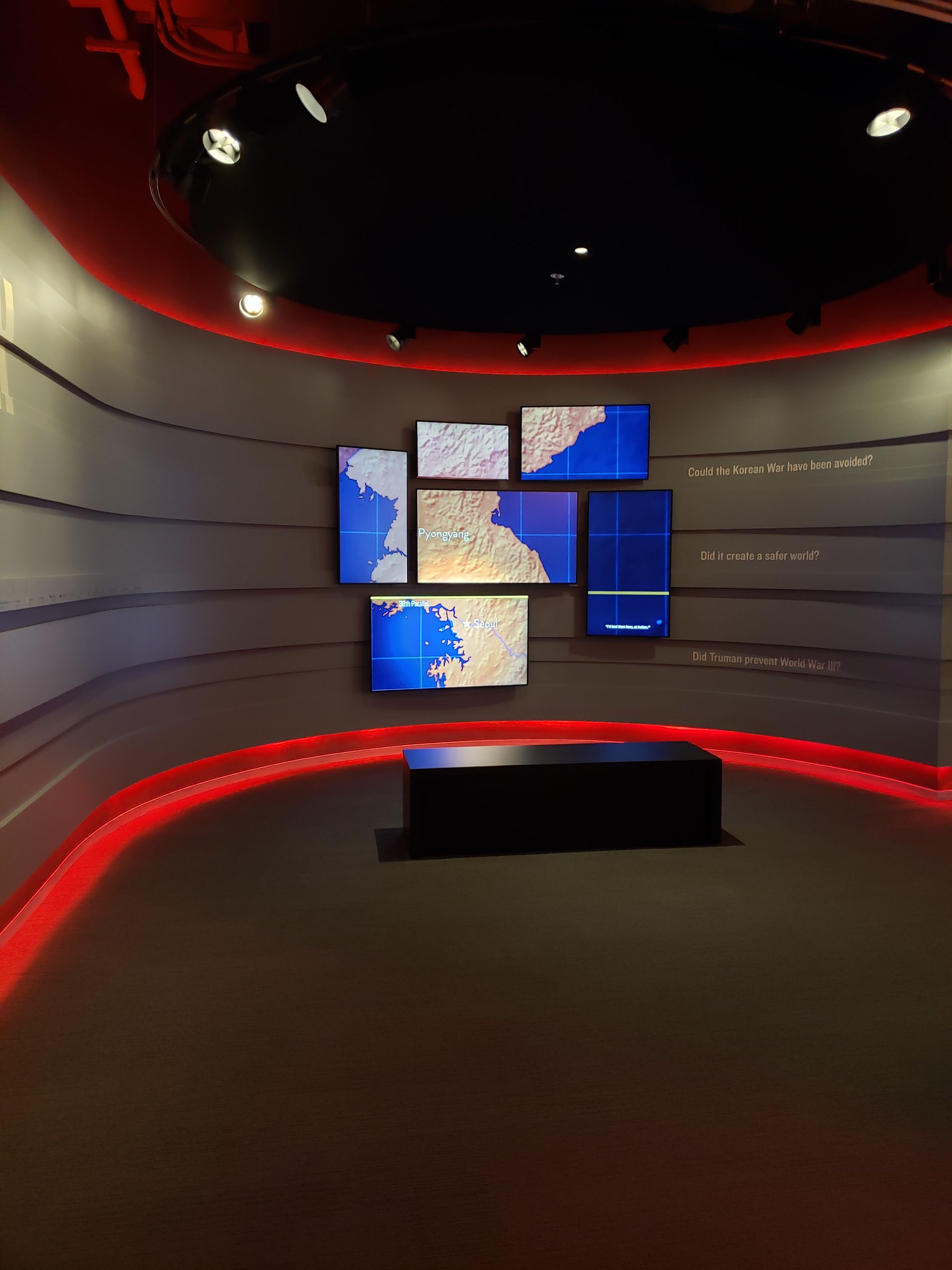 A room with a bunch of maps on the wall